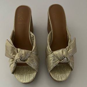 Brand  new with box .  Slip on and off wedge. Beautiful gold color.